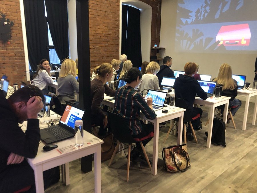 Participants working on laptops during an IT learning session.