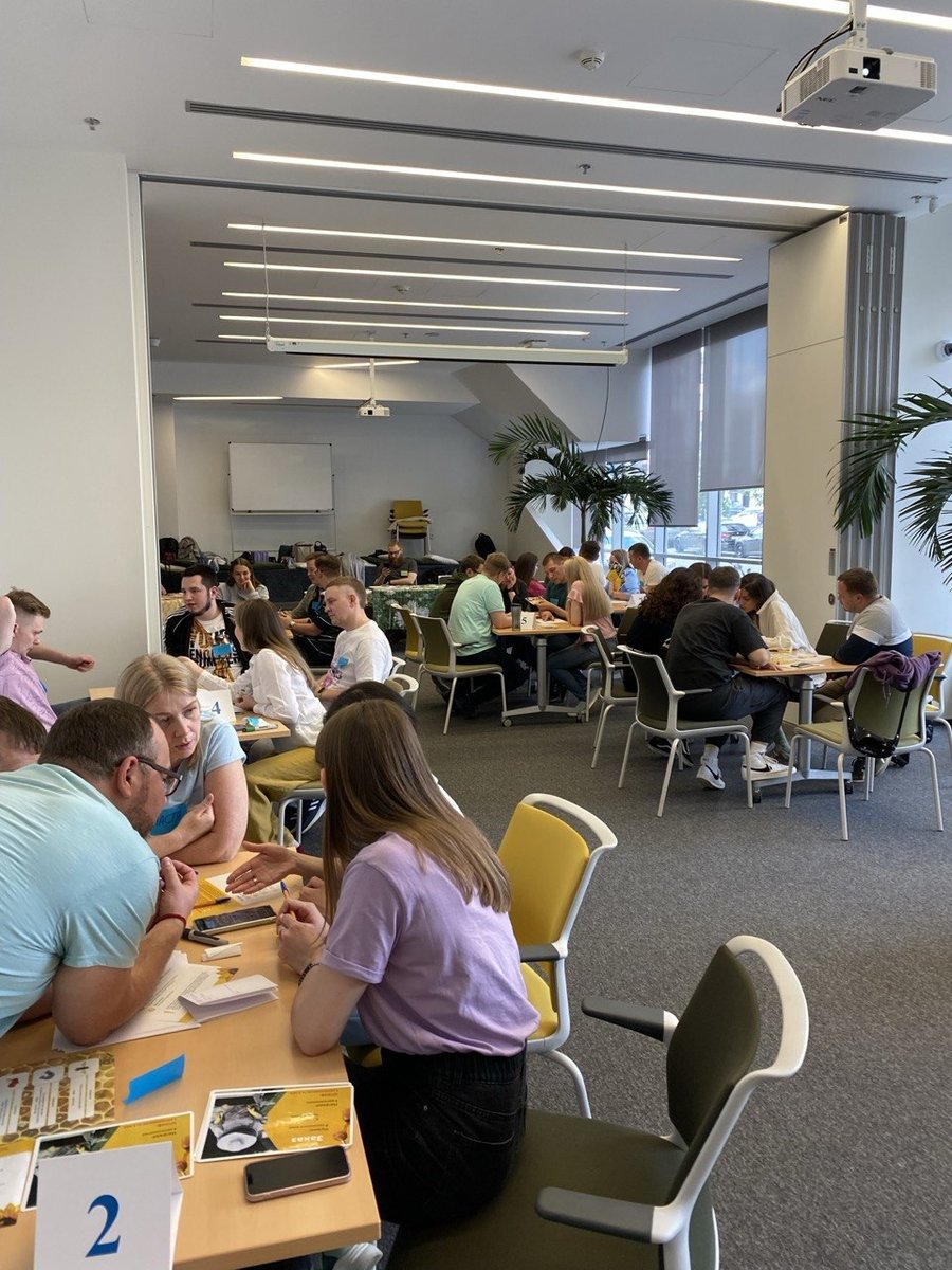 IT teams working at tables during a team session.